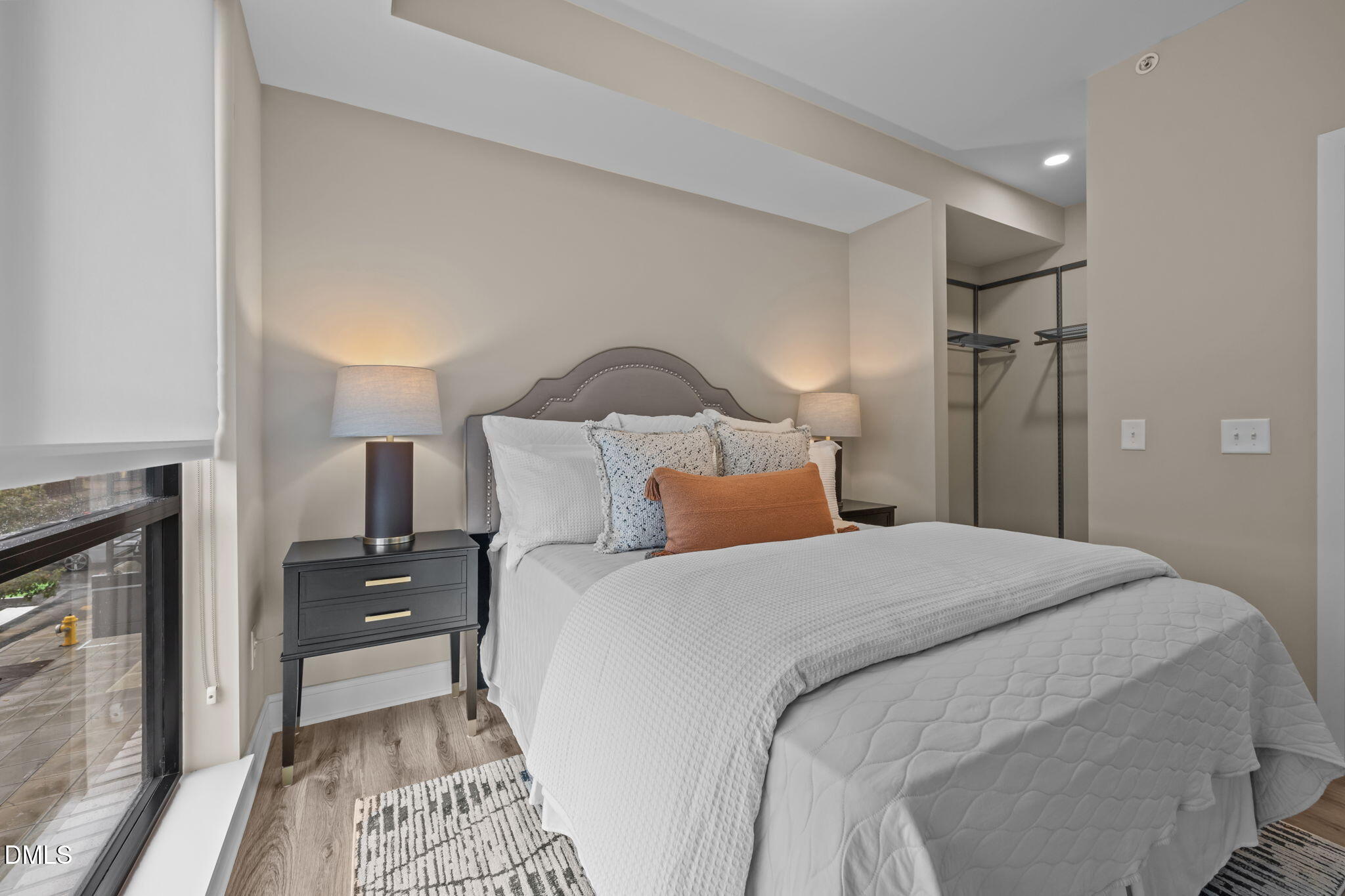 615 West Peace Street, Unit 202 Raleigh, NC 27603 - Photo 10 of 24 a bedroom with a bed and a mirror