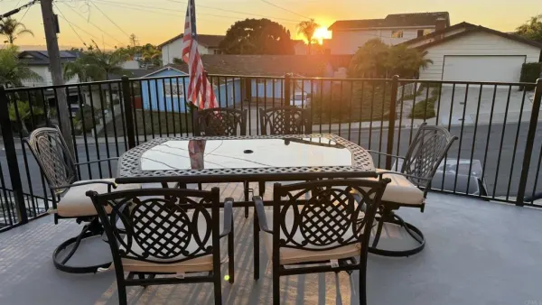 a view of a chairs and table in the balcony