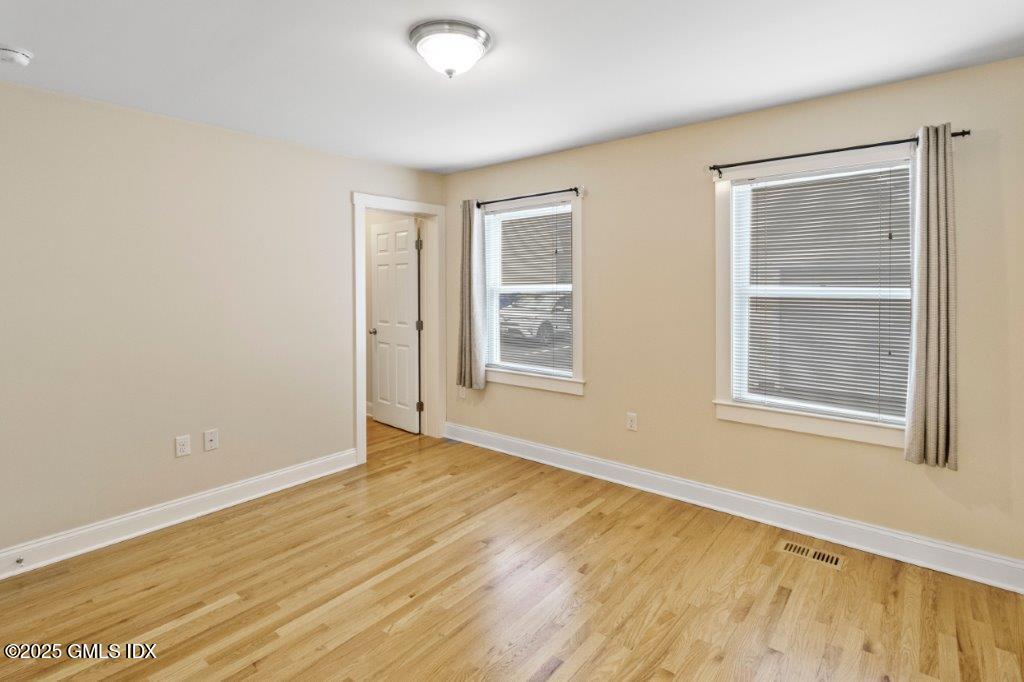 18 Charles Street, Unit B Greenwich, CT 06830 - Photo 11 of 14 a view of an empty room with wooden floor and a window