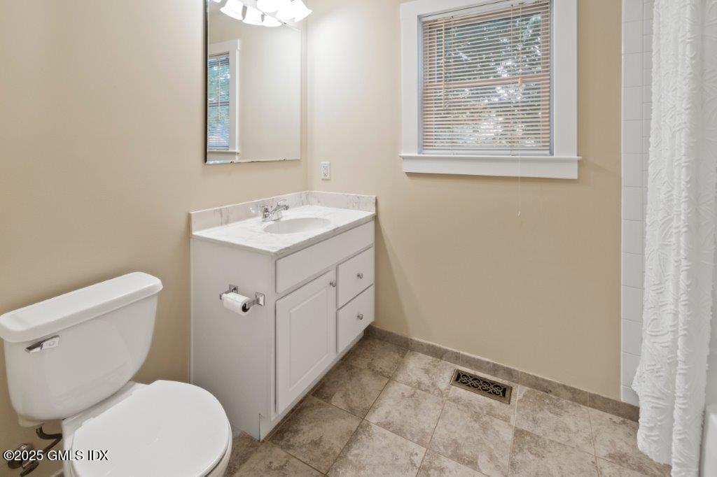 18 Charles Street, Unit B Greenwich, CT 06830 - Photo 13 of 14 a bathroom with a toilet sink and mirror