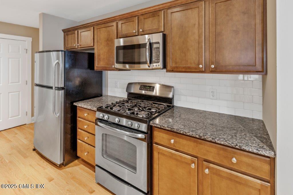 18 Charles Street, Unit B Greenwich, CT 06830 - Photo 2 of 14 a kitchen with stainless steel appliances granite countertop a refrigerator stove and microwave