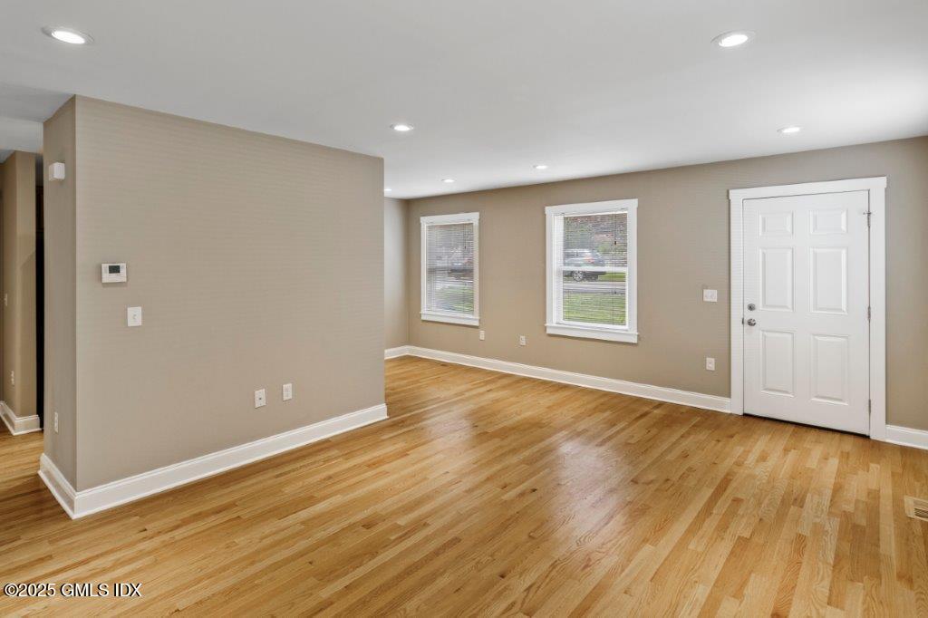 18 Charles Street, Unit B Greenwich, CT 06830 - Photo 5 of 14 an empty room with wooden floor and windows