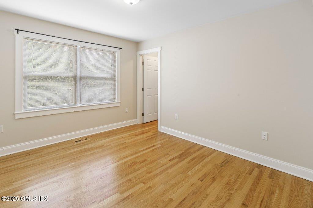 18 Charles Street, Unit B Greenwich, CT 06830 - Photo 6 of 14 a view of an empty room with wooden floor and a window