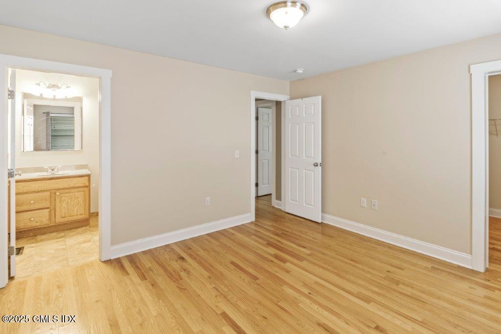 18 Charles Street, Unit B Greenwich, CT 06830 - Photo 7 of 14 a view of an empty room with window and wooden floor