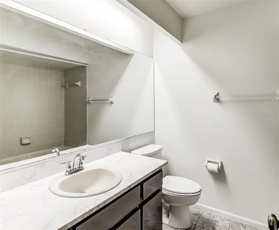 a bathroom with a sink toilet and a mirror