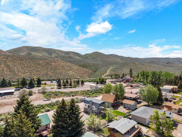 85 B Street, Unit 22 St. Charles, ID 83272 - Photo 34 of 35 Aerial perspective showcasing a residential community nestled against a backdrop of rolling hills