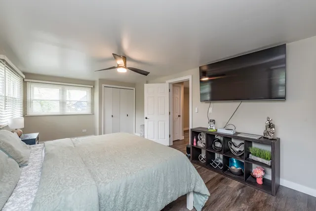 a bedroom with furniture and a flat screen tv