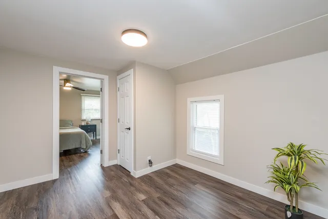 a view of a room with wooden floor and bedroom view