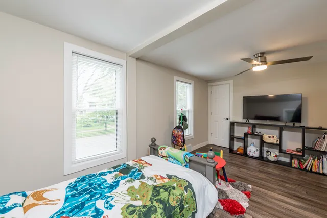 a bedroom with bed and a flat screen tv