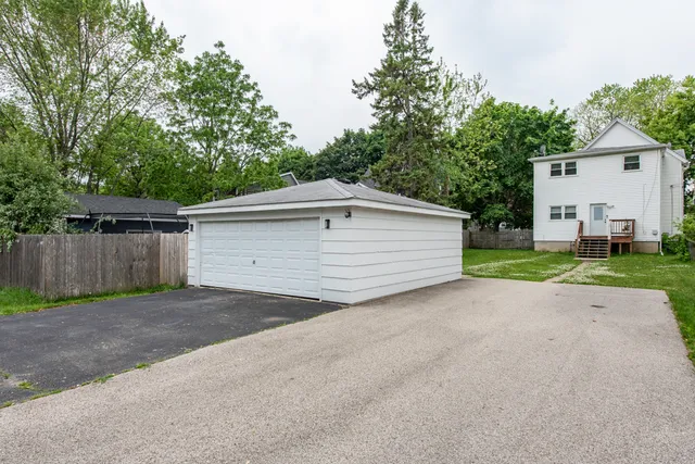 a view of a house with a yard and garage