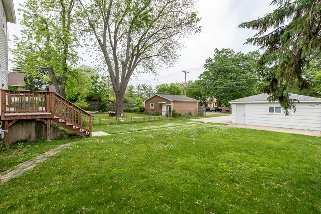 a view of a house with backyard and sitting area