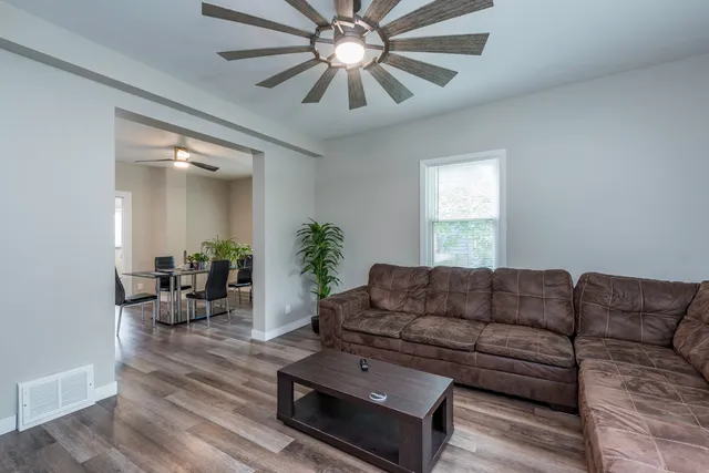 a living room with furniture a chandelier and a couch