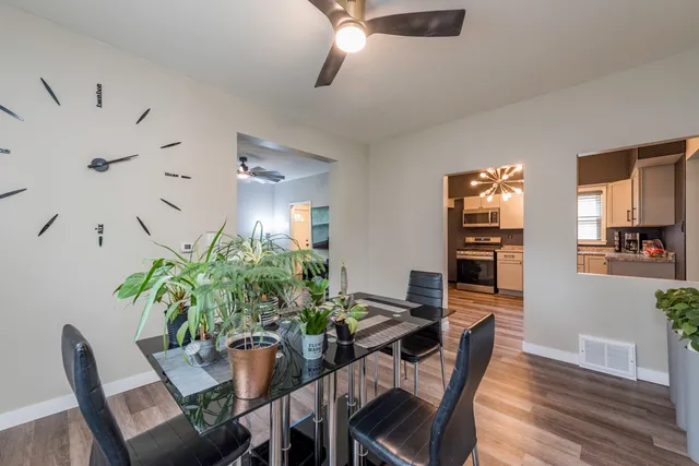 a view of a dining room with furniture and wooden floor