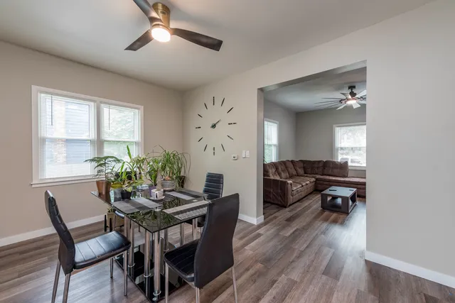 a view of a dining room with furniture and wooden floor