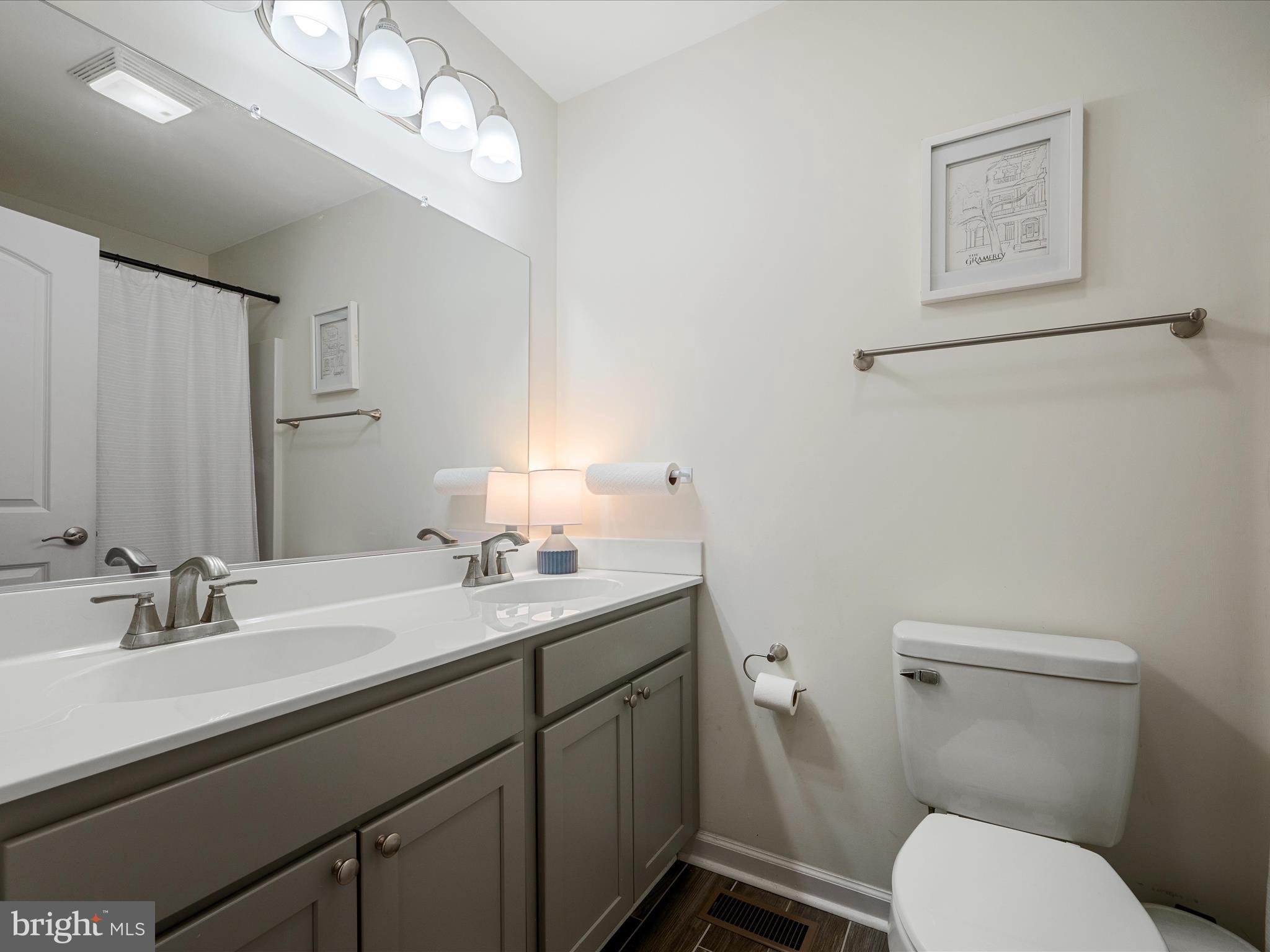 439 Windy Way Front Royal, VA 22630 - Photo 21 of 40 a bathroom with a toilet a sink and mirror