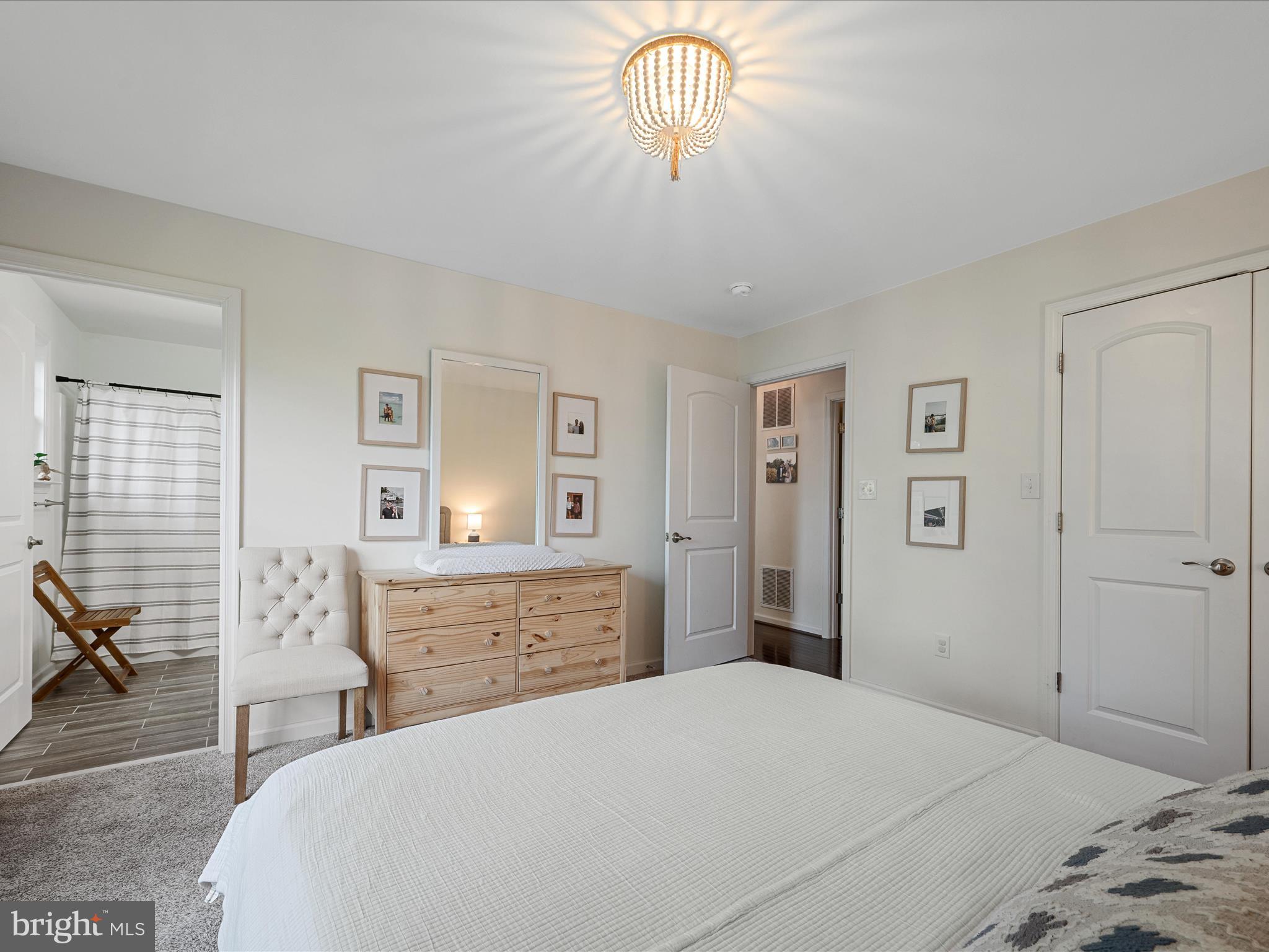 439 Windy Way Front Royal, VA 22630 - Photo 25 of 40 a bedroom with a bed and a chandelier