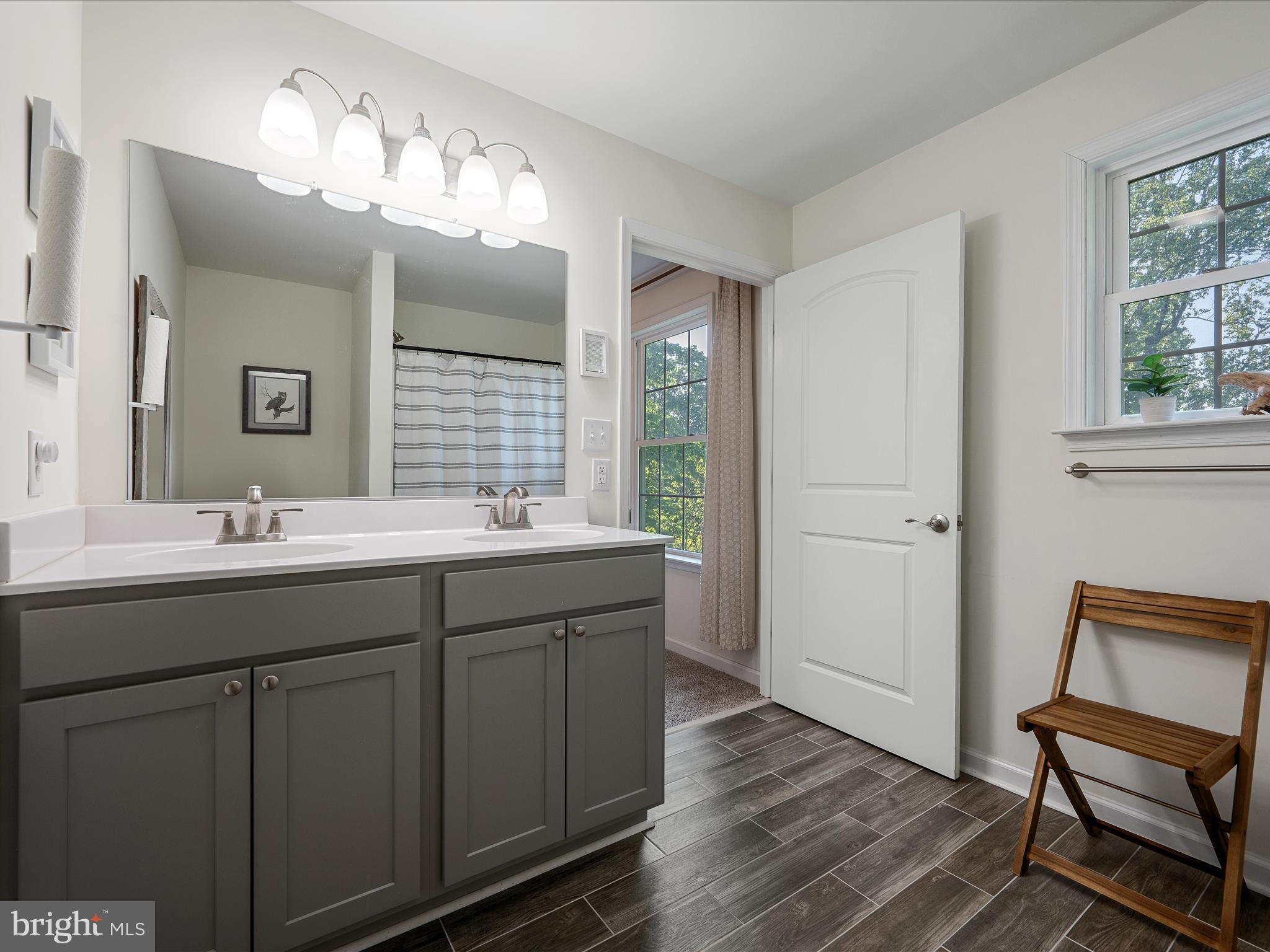 439 Windy Way Front Royal, VA 22630 - Photo 27 of 40 a bathroom with a double vanity sink and a mirror