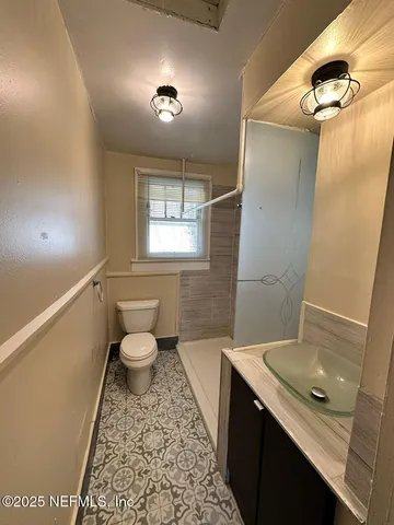 a bathroom with a sink toilet and shower