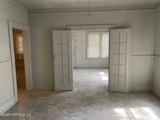 an empty room with windows and closet