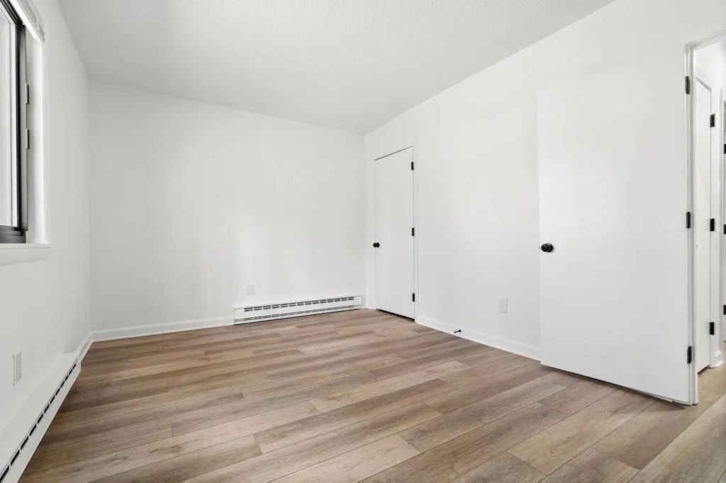 18 Pierce Street, Unit 3B Foxboro, MA 02035 - Photo 14 of 21 a view of an empty room with wooden floor