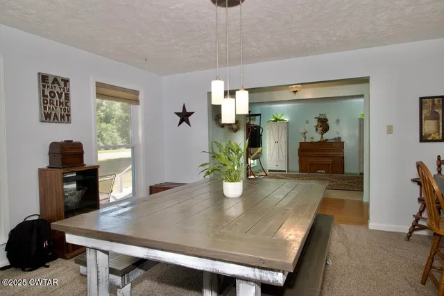 a kitchen with stainless steel appliances granite countertop a refrigerator a sink dishwasher a stove top oven a refrigerator and island with wooden floor