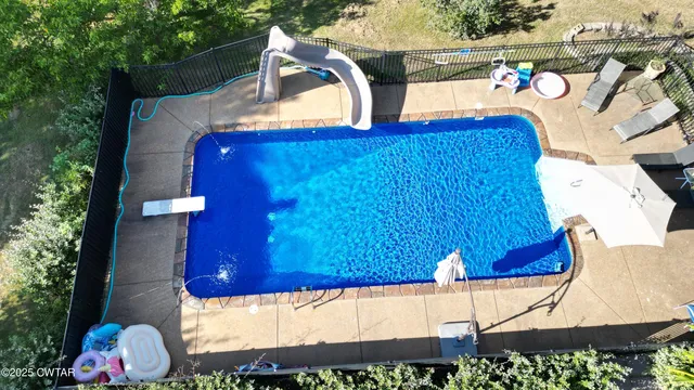 a view of swimming pool with a patio