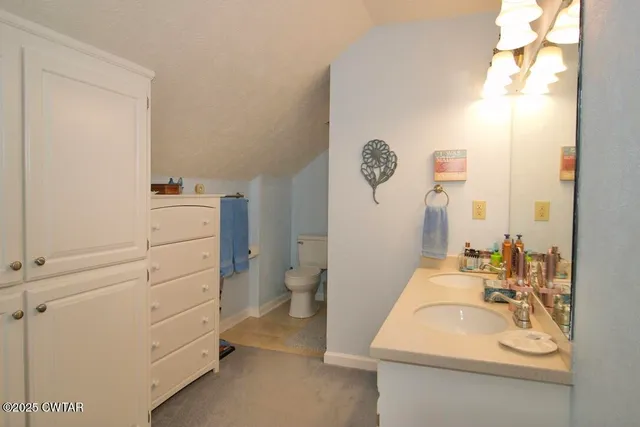 a bedroom with bed and a chandelier