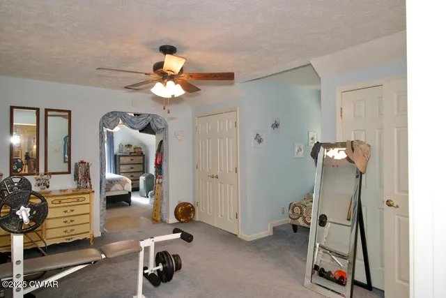 a bedroom with furniture and a gate