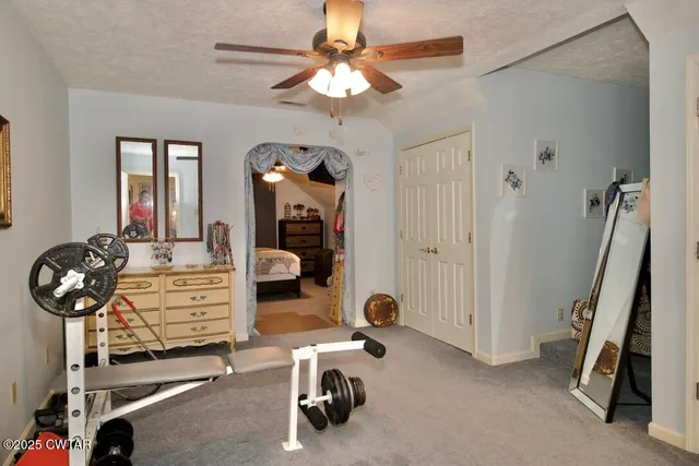 a living room with furniture a chandelier and a dining table