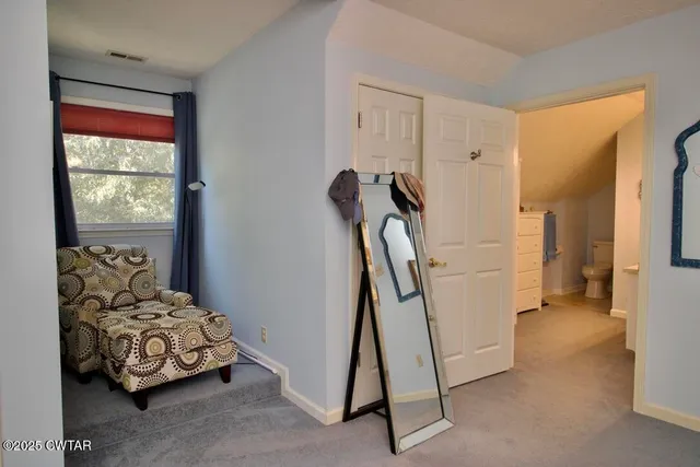 a living room with a couch and a book shelf