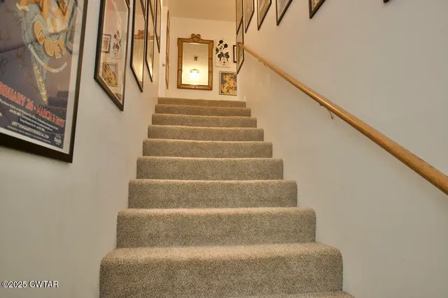a spacious bedroom with a bed and a chandelier