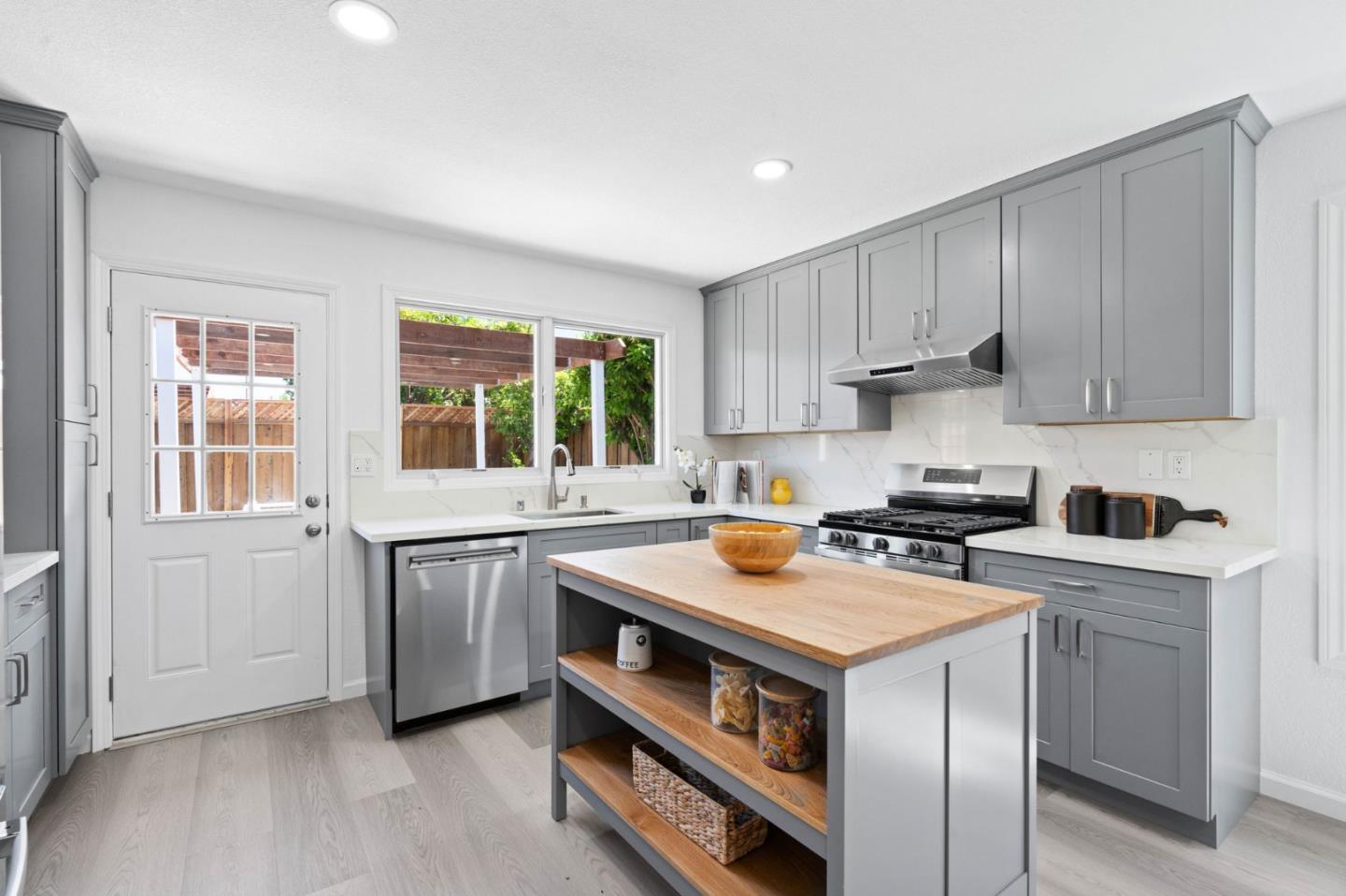 960 Cheswick Drive San Jose, CA 95121 - Photo 11 of 44 a utility room with stainless steel appliances granite countertop a stove and a sink