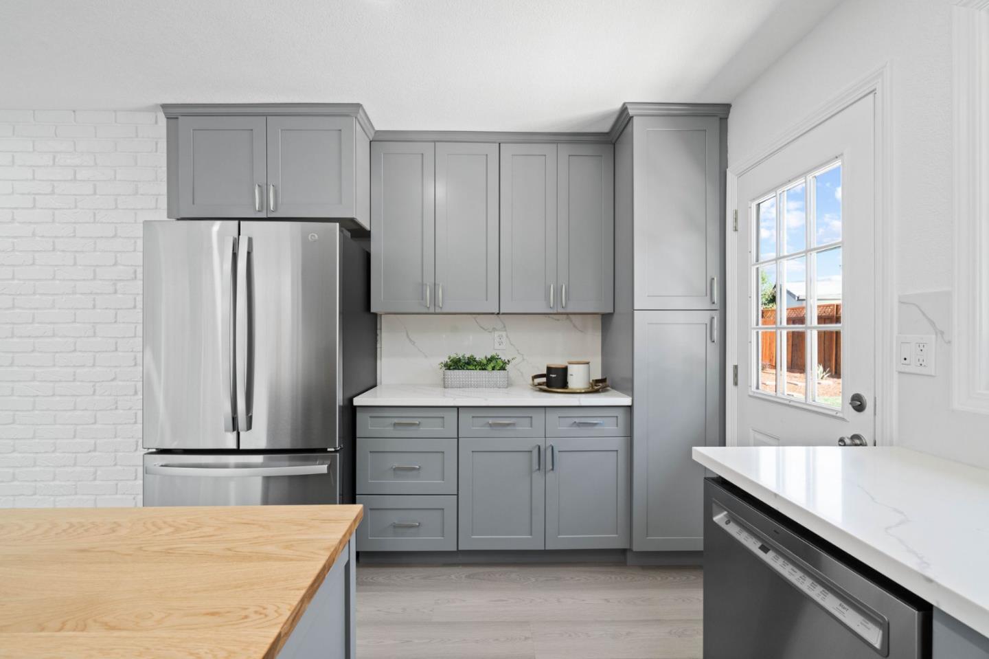 960 Cheswick Drive San Jose, CA 95121 - Photo 13 of 44 a kitchen with stainless steel appliances a refrigerator sink and cabinets