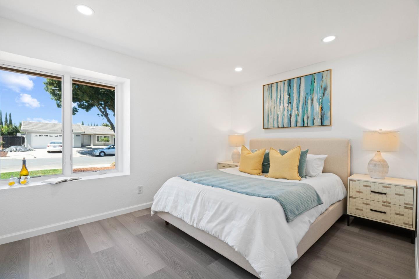 960 Cheswick Drive San Jose, CA 95121 - Photo 16 of 44 a bedroom with a bed a mirror and a large window