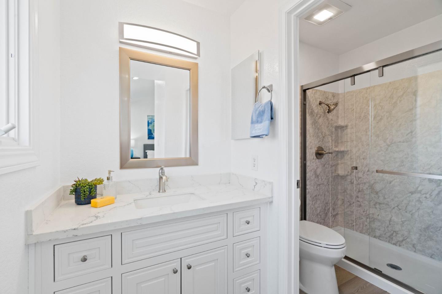 960 Cheswick Drive San Jose, CA 95121 - Photo 19 of 44 a bathroom with a sink a toilet a shower and a mirror