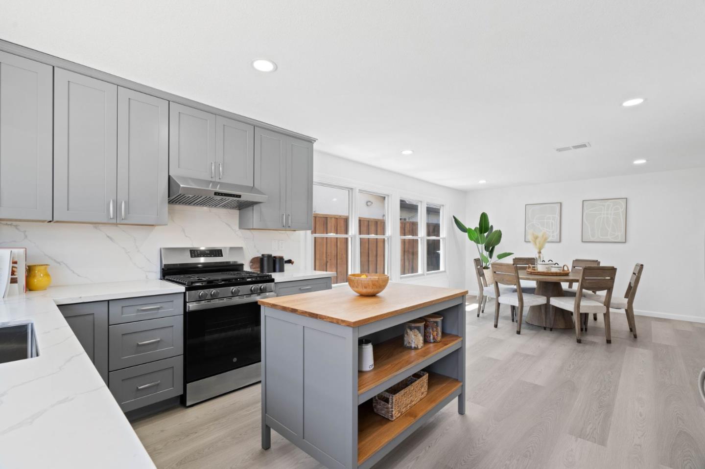 960 Cheswick Drive San Jose, CA 95121 - Photo 9 of 44 a kitchen with stainless steel appliances granite countertop a stove and a table chairs