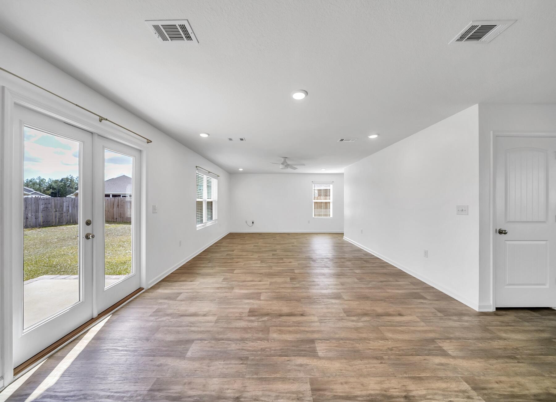 955 Merganser Way Crestview, FL 32539 - Photo 12 of 34 a view of empty room with wooden floor