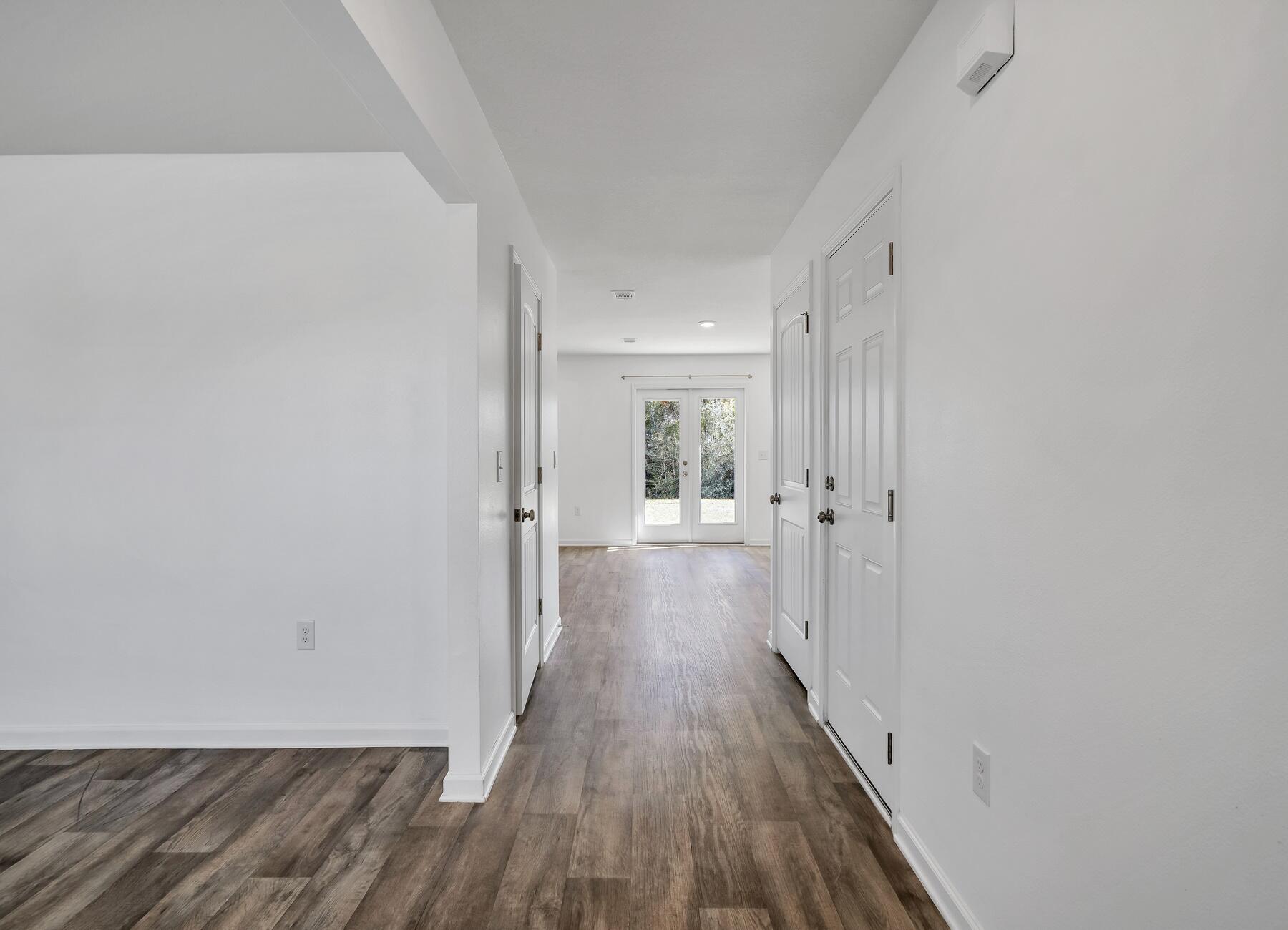 955 Merganser Way Crestview, FL 32539 - Photo 2 of 34 a view of a hallway with wooden floor
