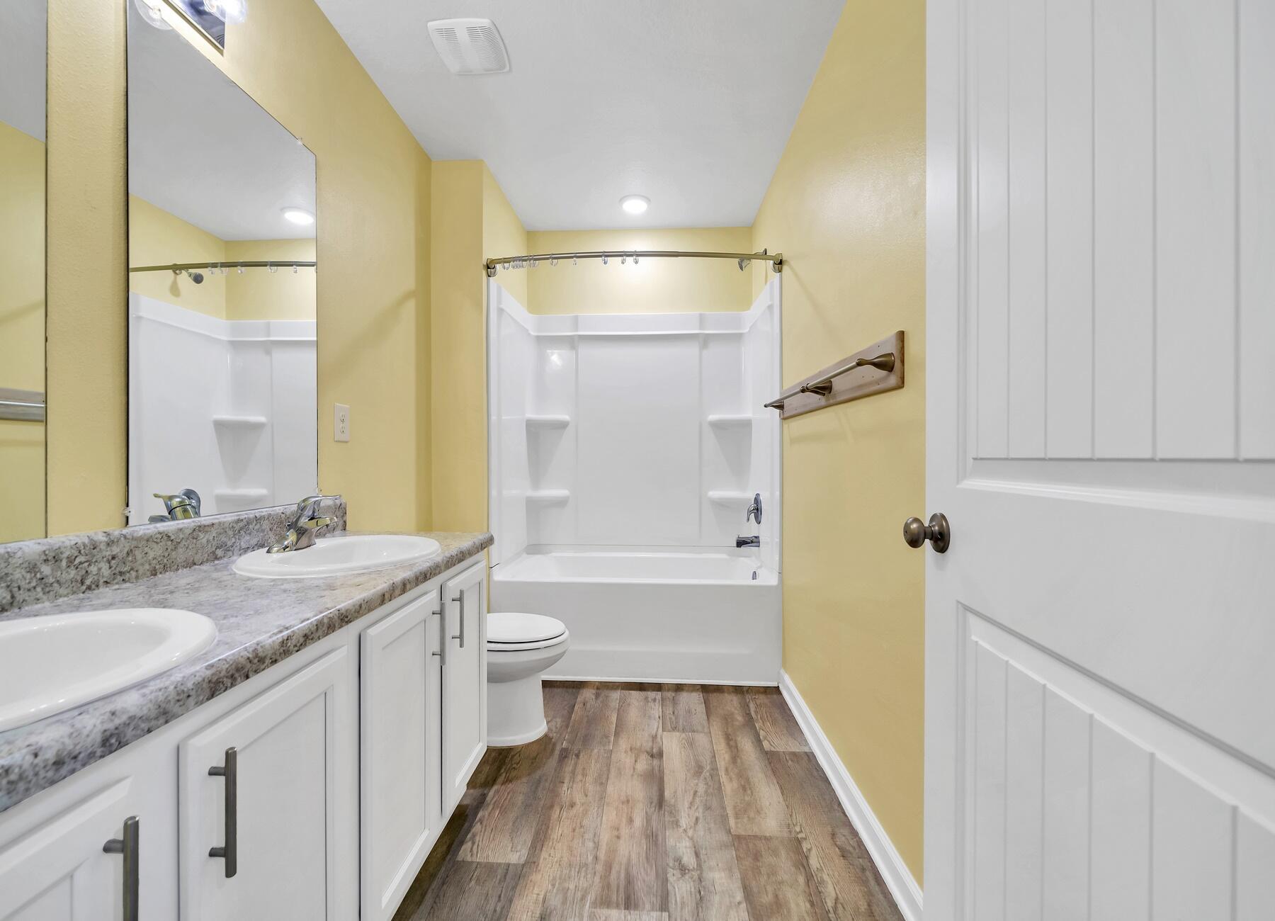 955 Merganser Way Crestview, FL 32539 - Photo 21 of 34 a bathroom with a granite countertop sink toilet and shower