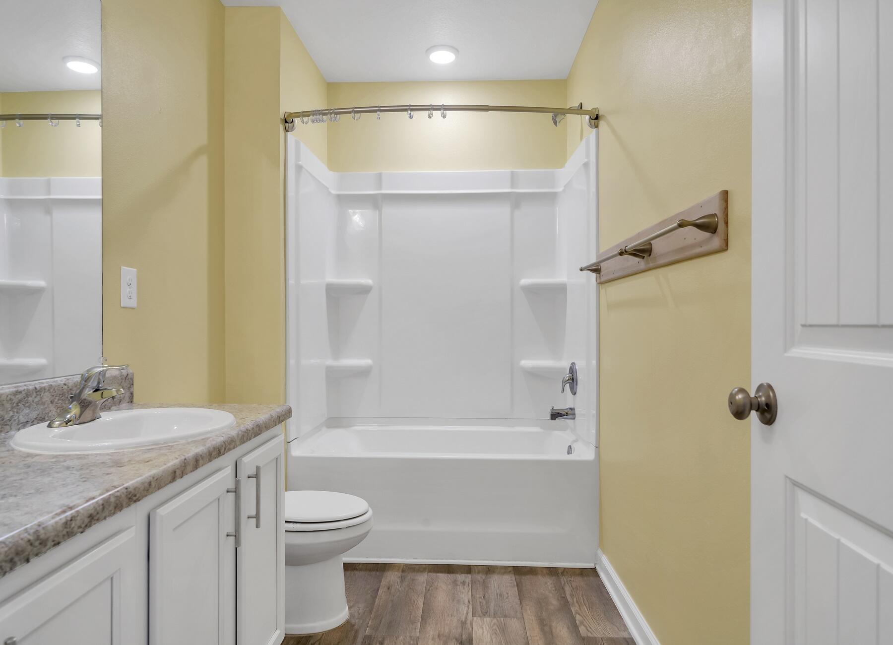 955 Merganser Way Crestview, FL 32539 - Photo 22 of 34 a bathroom with a granite countertop sink toilet and shower