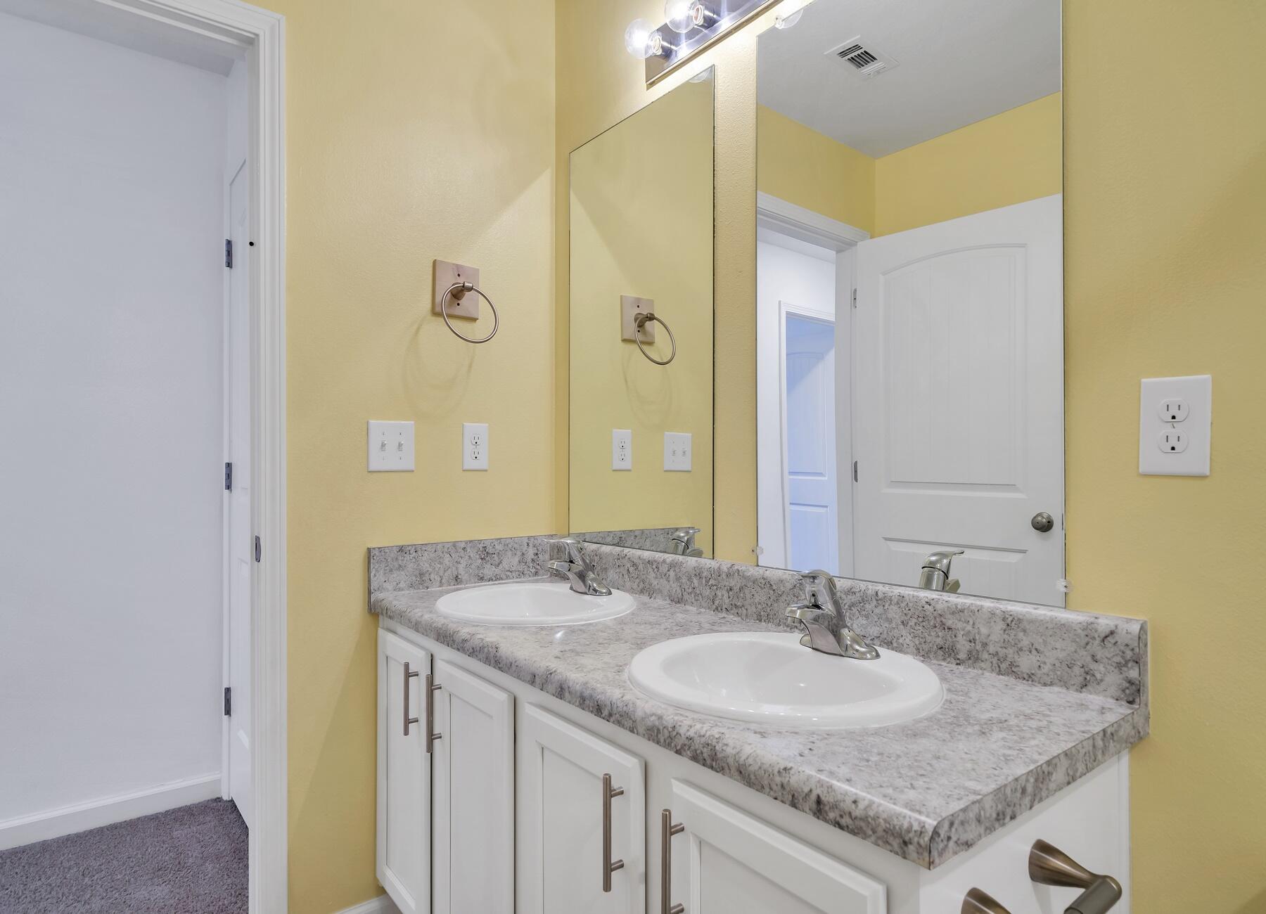 955 Merganser Way Crestview, FL 32539 - Photo 23 of 34 a bathroom with a granite countertop sink and a mirror