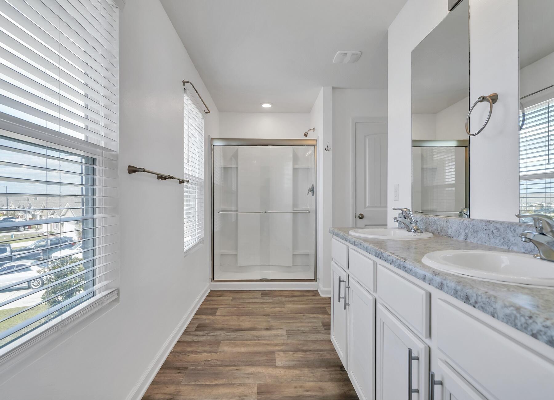 955 Merganser Way Crestview, FL 32539 - Photo 28 of 34 a bathroom with a granite countertop sink a mirror and a shower