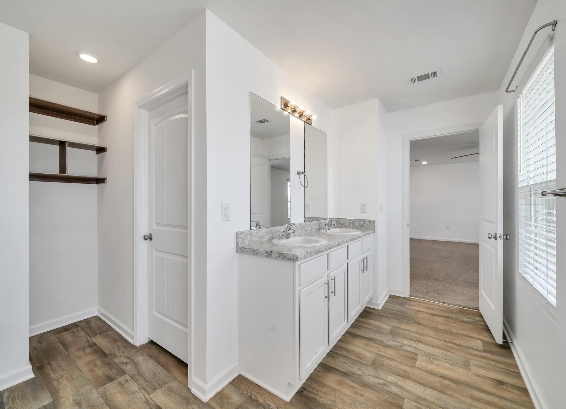 955 Merganser Way Crestview, FL 32539 - Photo 30 of 34 a bathroom with a granite countertop sink and a mirror