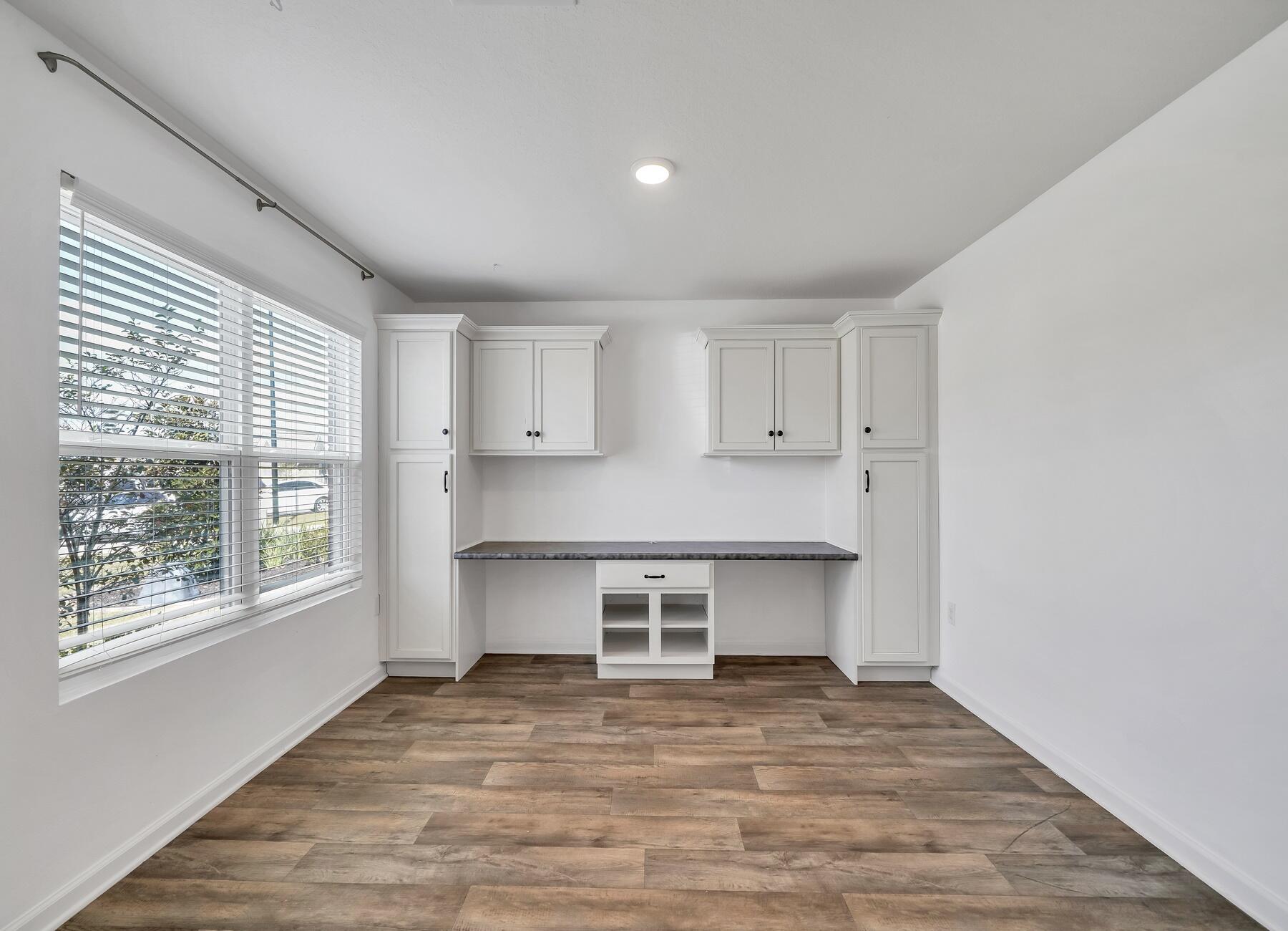 955 Merganser Way Crestview, FL 32539 - Photo 3 of 34 a view of a kitchen with wooden floor and a window