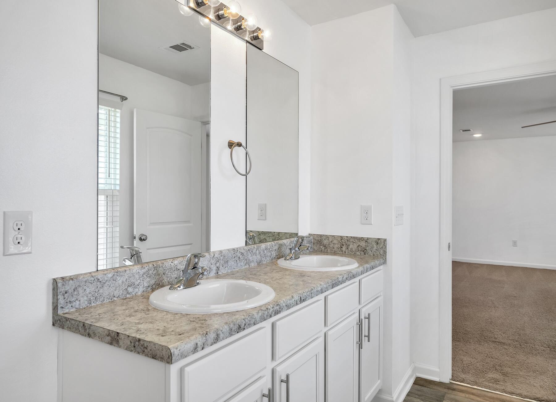955 Merganser Way Crestview, FL 32539 - Photo 31 of 34 a bathroom with a sink and a mirror