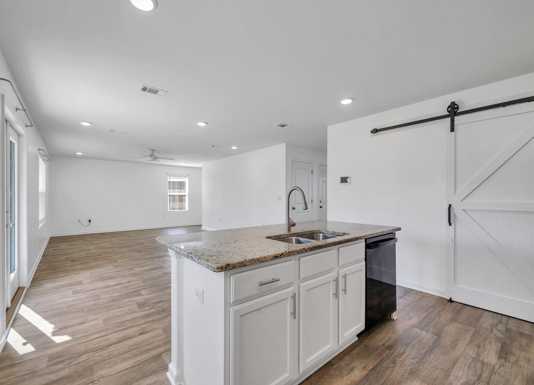 955 Merganser Way Crestview, FL 32539 - Photo 9 of 34 a kitchen with a sink refrigerator and cabinets