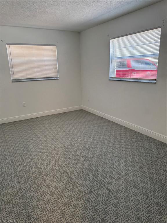 3325 Airport-Pulling Road North, Unit E4 Naples, FL 34105 - Photo 3 of 11 an empty room with a window