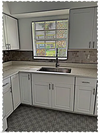 a kitchen with a sink and cabinets