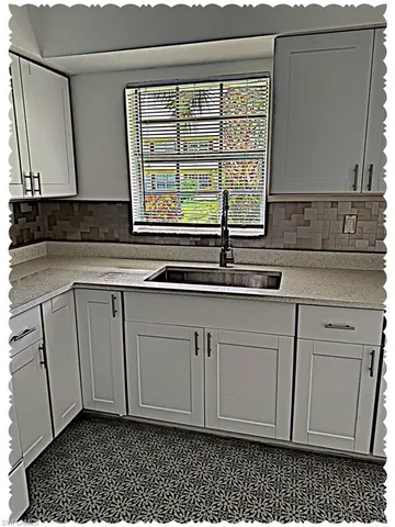 a kitchen with a sink and cabinets