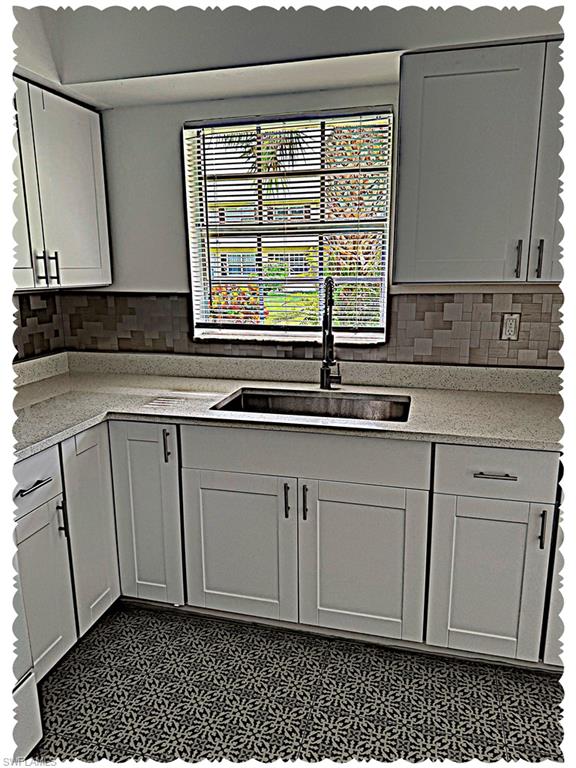 3325 Airport-Pulling Road North, Unit E4 Naples, FL 34105 - Photo 7 of 11 a kitchen with a sink and cabinets